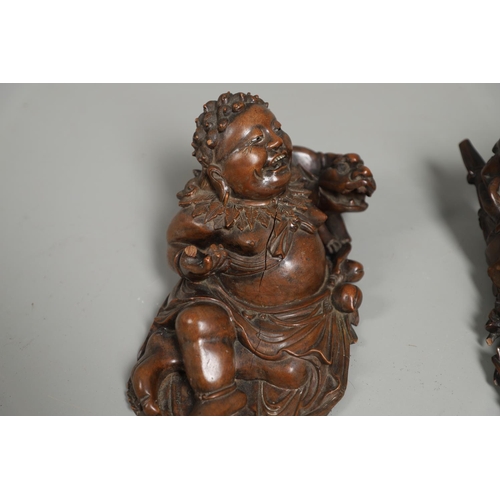 844 - TWO 19THC CHINESE CARVED BUDDHA GROUPS. Two well carved 19thc large carved wooden groups of reclinin... 