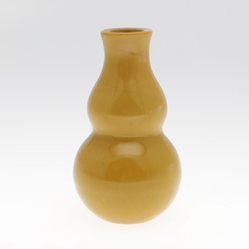 853 - A CHINESE BEIJING GLASS VASE. Probably 19thc, the double gourd shaped vase in an ochre colour. Unmar... 