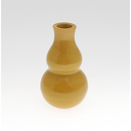 853 - A CHINESE BEIJING GLASS VASE. Probably 19thc, the double gourd shaped vase in an ochre colour. Unmar... 