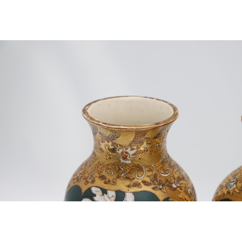 854 - PAIR OF LARGE JAPANESE SATSUMA VASES. Meiji period, each side painted with panels of flowers on a gr... 