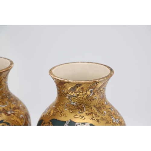 854 - PAIR OF LARGE JAPANESE SATSUMA VASES. Meiji period, each side painted with panels of flowers on a gr... 