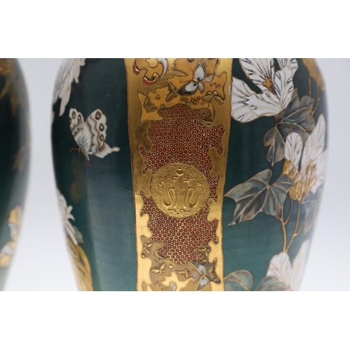 854 - PAIR OF LARGE JAPANESE SATSUMA VASES. Meiji period, each side painted with panels of flowers on a gr... 