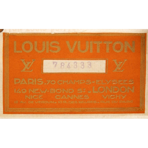 572 - VINTAGE LOUIS VUITTON TRUNK. A vintage early 20thc trunk with monogrammed exterior, with wooden slat... 