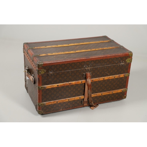 572 - VINTAGE LOUIS VUITTON TRUNK. A vintage early 20thc trunk with monogrammed exterior, with wooden slat... 