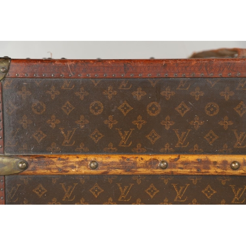 572 - VINTAGE LOUIS VUITTON TRUNK. A vintage early 20thc trunk with monogrammed exterior, with wooden slat... 