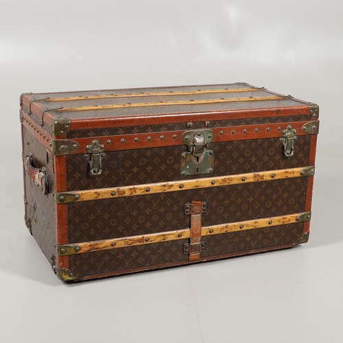 572 - VINTAGE LOUIS VUITTON TRUNK. A vintage early 20thc trunk with monogrammed exterior, with wooden slat... 