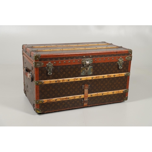 572 - VINTAGE LOUIS VUITTON TRUNK. A vintage early 20thc trunk with monogrammed exterior, with wooden slat... 