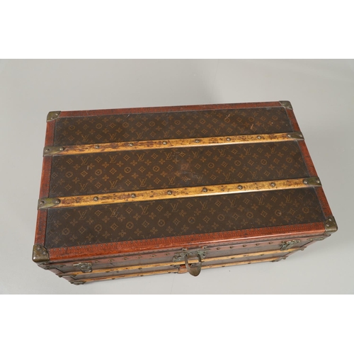 572 - VINTAGE LOUIS VUITTON TRUNK. A vintage early 20thc trunk with monogrammed exterior, with wooden slat... 