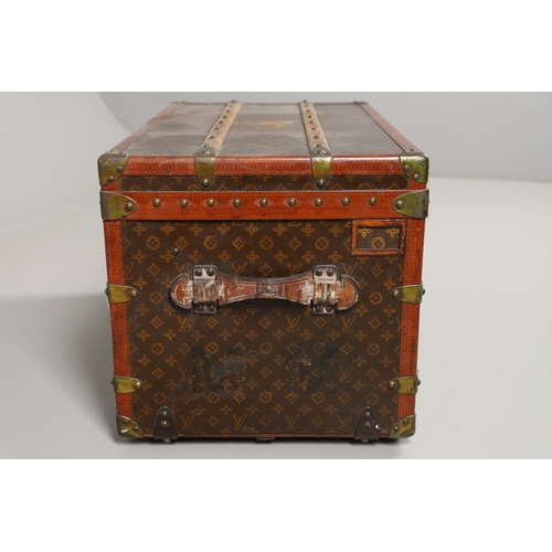 572 - VINTAGE LOUIS VUITTON TRUNK. A vintage early 20thc trunk with monogrammed exterior, with wooden slat... 