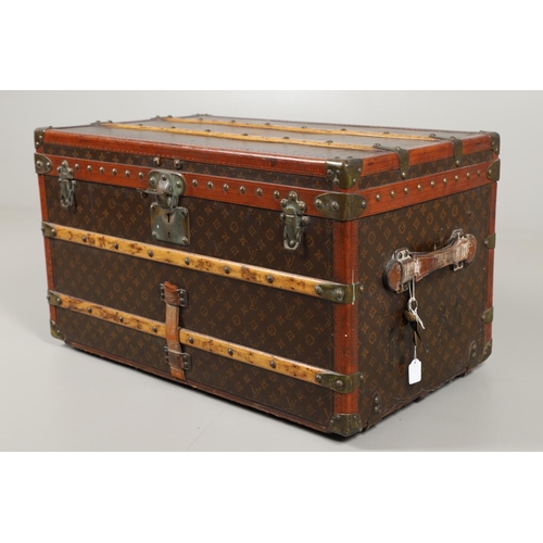 572 - VINTAGE LOUIS VUITTON TRUNK. A vintage early 20thc trunk with monogrammed exterior, with wooden slat... 