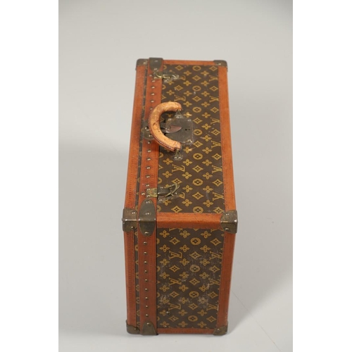 573 - VINTAGE LOUIS VUITTON SUITCASE. With a monogrammed exterior, leather trim with brass studs and brass... 