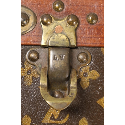 573 - VINTAGE LOUIS VUITTON SUITCASE. With a monogrammed exterior, leather trim with brass studs and brass... 