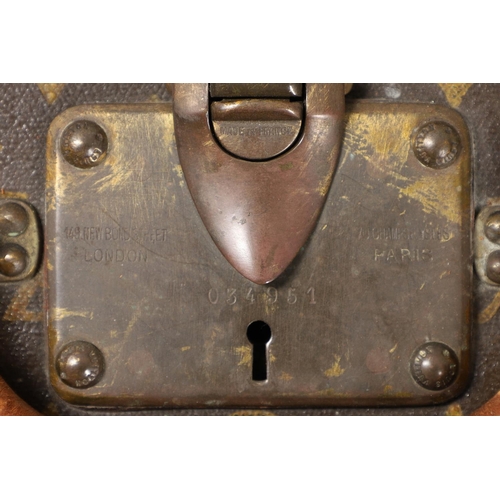 573 - VINTAGE LOUIS VUITTON SUITCASE. With a monogrammed exterior, leather trim with brass studs and brass... 