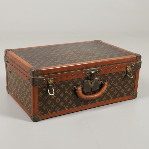 573 - VINTAGE LOUIS VUITTON SUITCASE. With a monogrammed exterior, leather trim with brass studs and brass... 