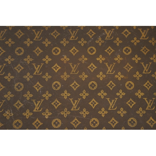 573 - VINTAGE LOUIS VUITTON SUITCASE. With a monogrammed exterior, leather trim with brass studs and brass... 