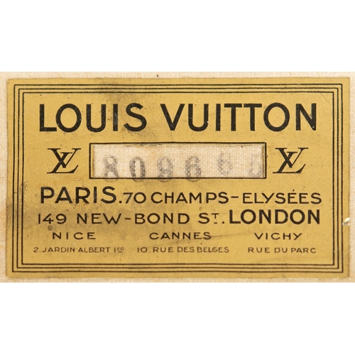 574 - VINTAGE LOUIS VUITTON SUITCASE. An early 20thc suitcase, with a monogrammed exterior, leather trim w... 