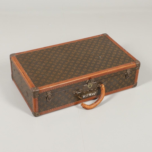 574 - VINTAGE LOUIS VUITTON SUITCASE. An early 20thc suitcase, with a monogrammed exterior, leather trim w... 