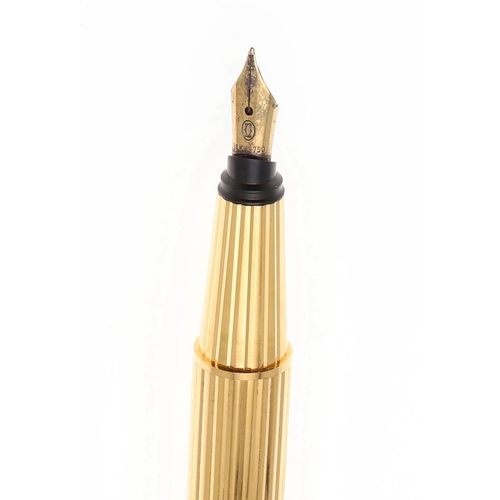 577 - PASHA DE CARTIER FOUNTAIN PEN. A gold plated fountain pen with a 18k gold nib, the cap with a clip a... 