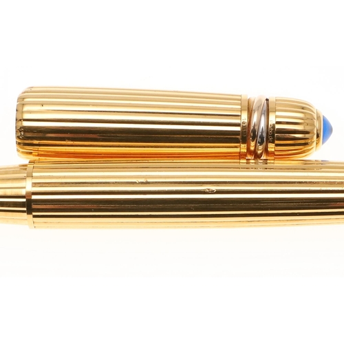 577 - PASHA DE CARTIER FOUNTAIN PEN. A gold plated fountain pen with a 18k gold nib, the cap with a clip a... 