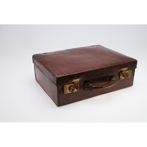 635 - FITTED CROCODILE SKIN SUITCASE - F H HAUPT, HAMBURG. A Crocodile skin suitcase with brass locks, sta... 