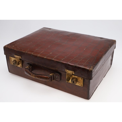 635 - FITTED CROCODILE SKIN SUITCASE - F H HAUPT, HAMBURG. A Crocodile skin suitcase with brass locks, sta... 