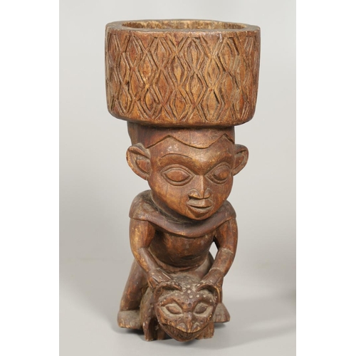 640 - CAMEROON TRIBAL POUNDING BOWL & LUBA-HEMBA TRIBAL STOOL. A carved tribal pounding bowl, the figure w... 