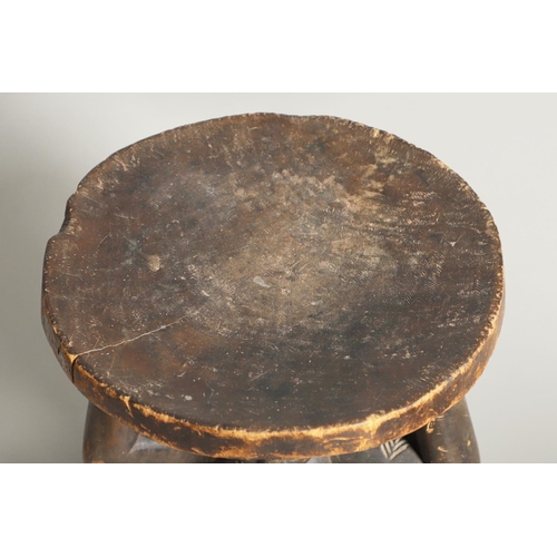 640 - CAMEROON TRIBAL POUNDING BOWL & LUBA-HEMBA TRIBAL STOOL. A carved tribal pounding bowl, the figure w... 