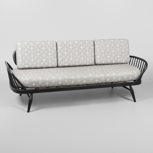 663 - A MODERN ERCOL DAY BED. A modern ebonised day bed, after Model 355 designed by Lucian Ercolani. With... 