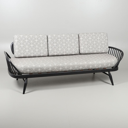 663 - A MODERN ERCOL DAY BED. A modern ebonised day bed, after Model 355 designed by Lucian Ercolani. With... 