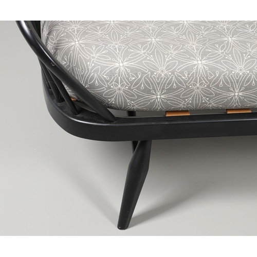 663 - A MODERN ERCOL DAY BED. A modern ebonised day bed, after Model 355 designed by Lucian Ercolani. With... 