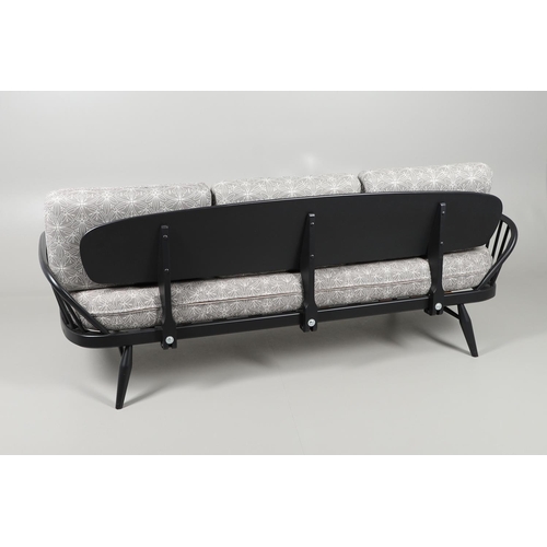 663 - A MODERN ERCOL DAY BED. A modern ebonised day bed, after Model 355 designed by Lucian Ercolani. With... 