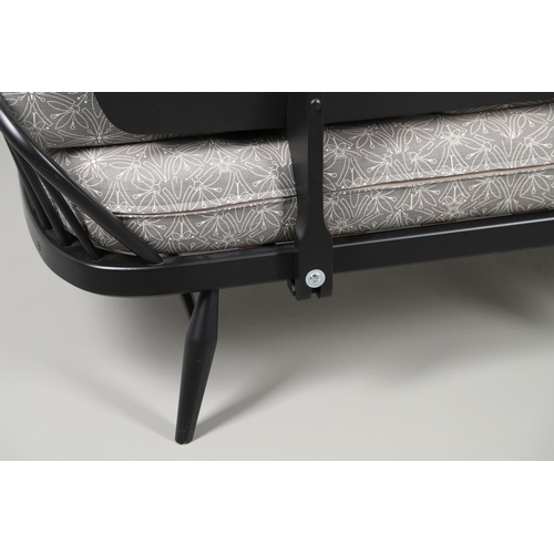 663 - A MODERN ERCOL DAY BED. A modern ebonised day bed, after Model 355 designed by Lucian Ercolani. With... 