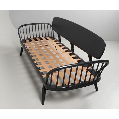 663 - A MODERN ERCOL DAY BED. A modern ebonised day bed, after Model 355 designed by Lucian Ercolani. With... 