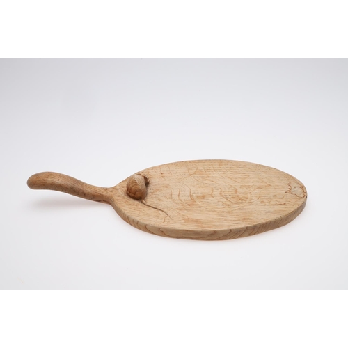 665 - ROBERT THOMPSON OF KILBURN CHEESE BOARD & TWO SMALL DISHES. An oval cheese board with curved handle ... 