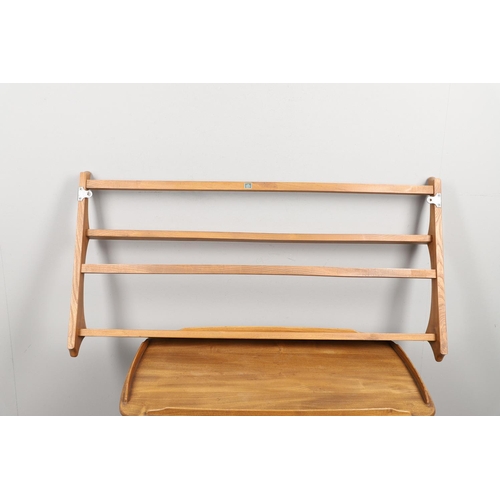 668 - ERCOL TEA TROLLEY & PLATE RACK. A three tier light elm and beech tea trolley, raised on roller casto... 