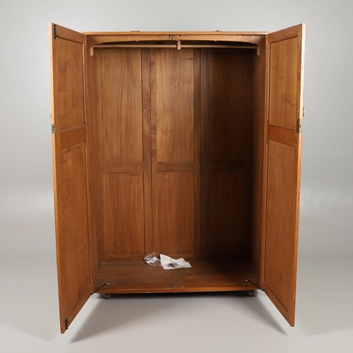 670 - ERCOL ELM DOUBLE WARDROBE. An elm two door wardrobe with hanging rail, supported on roller casters. ... 