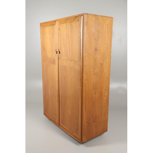 670 - ERCOL ELM DOUBLE WARDROBE. An elm two door wardrobe with hanging rail, supported on roller casters. ... 