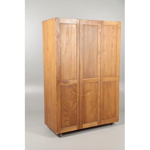 670 - ERCOL ELM DOUBLE WARDROBE. An elm two door wardrobe with hanging rail, supported on roller casters. ... 