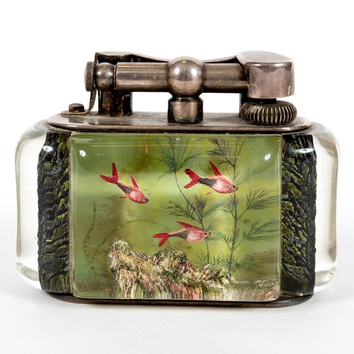 740 - DUNHILL AQUARIUM TABLE LIGHTER. A table lighter with lucite panels and silver plated mounts, carved ... 