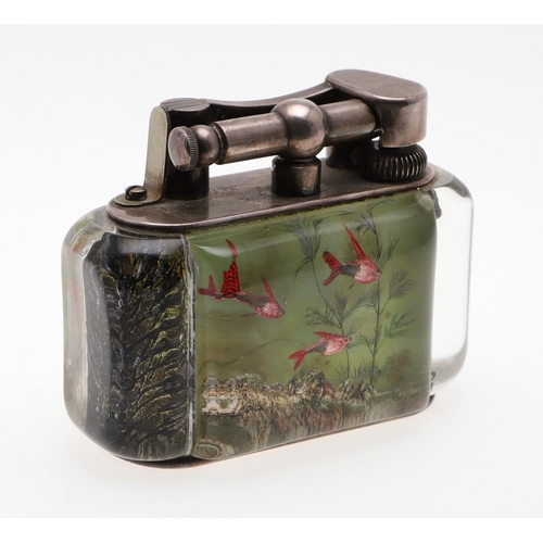 740 - DUNHILL AQUARIUM TABLE LIGHTER. A table lighter with lucite panels and silver plated mounts, carved ... 