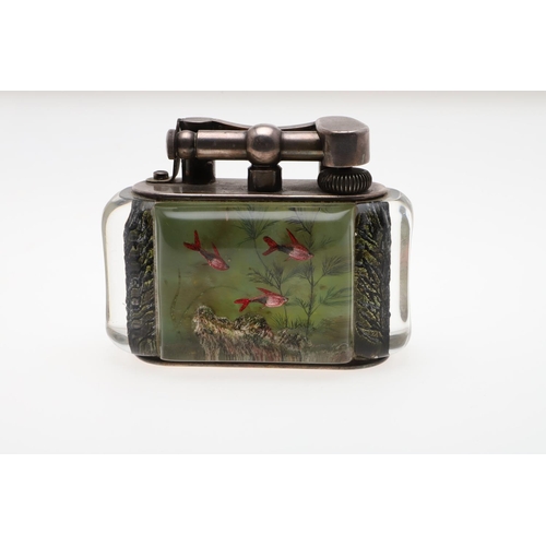 740 - DUNHILL AQUARIUM TABLE LIGHTER. A table lighter with lucite panels and silver plated mounts, carved ... 