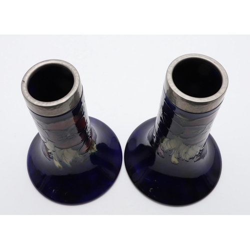 745 - PAIR OF ANTIQUE MOORCROFT VASES & PEWTER MOUNTS. A pair of bell shaped vases, painted in the Pansy d... 