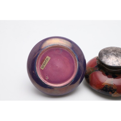 747 - ANTIQUE MOORCROFT INKWELLS. Including an unusual inkwell with a purple lustre glaze and pink undersi... 