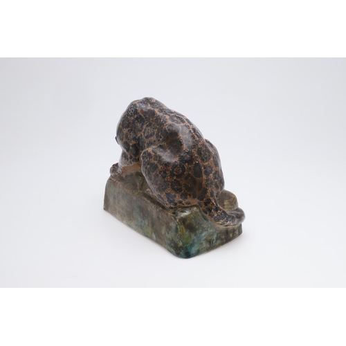 755 - STELLA CROFTS (1898-1964) - LARGE POTTERY CHEETAH. A large pottery figure of a Cheetah eating a piec... 