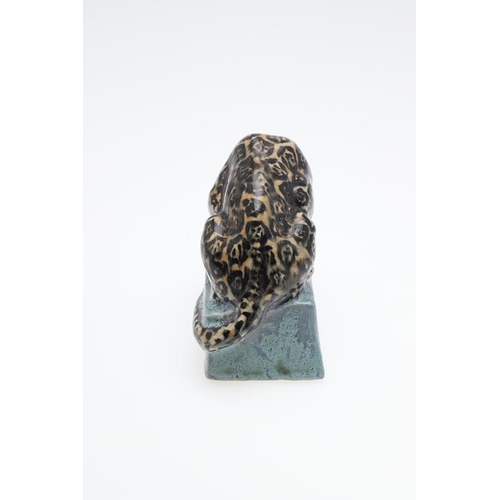 762 - STELLA CROFTS (1898-1964) - POTTERY LEOPARD. A small stoneware figure of a Leopard eating it's prey,... 