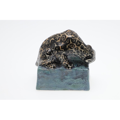 762 - STELLA CROFTS (1898-1964) - POTTERY LEOPARD. A small stoneware figure of a Leopard eating it's prey,... 