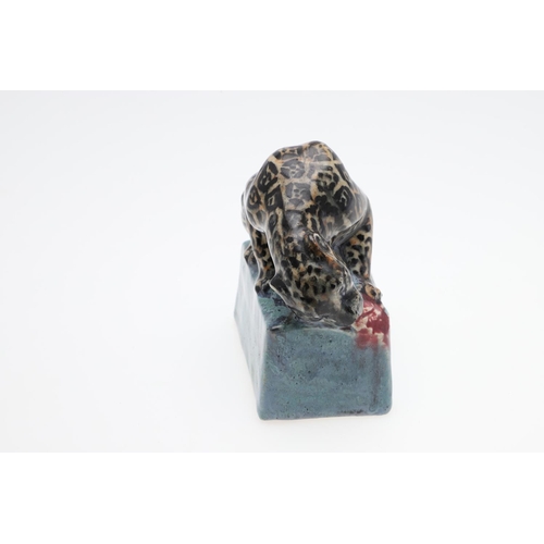 762 - STELLA CROFTS (1898-1964) - POTTERY LEOPARD. A small stoneware figure of a Leopard eating it's prey,... 