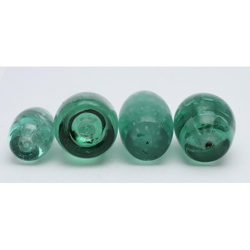 763 - VICTORIAN GLASS DUMPS. Four Victorian glass dumps, including one of narrow form with silver coloured... 