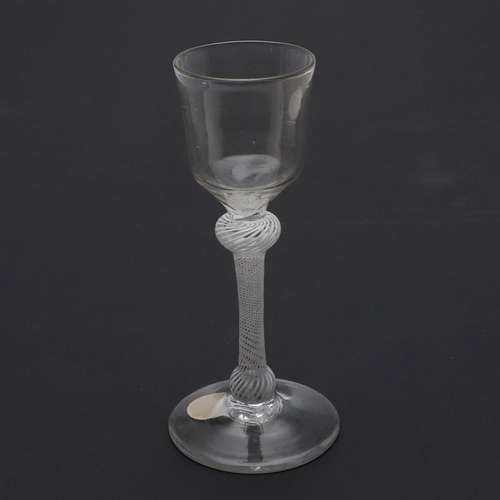 778 - 18THC WINE GLASS - OPAQUE TWIST. The wine glass with ogee shaped bowl, with shoulder and lower knop ... 