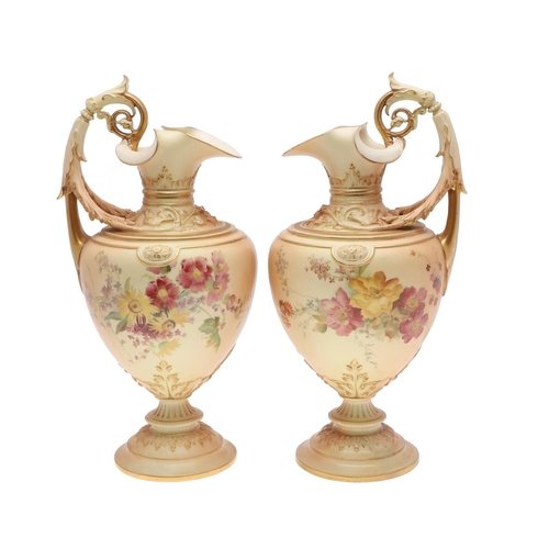 800 - LARGE PAIR OF ROYAL WORCESTER EWERS. A pair of blush ivory ewers, with acanthus shaped handle and th... 